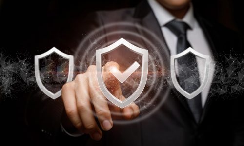 Businessman exposes the selected system protection on a dark background.